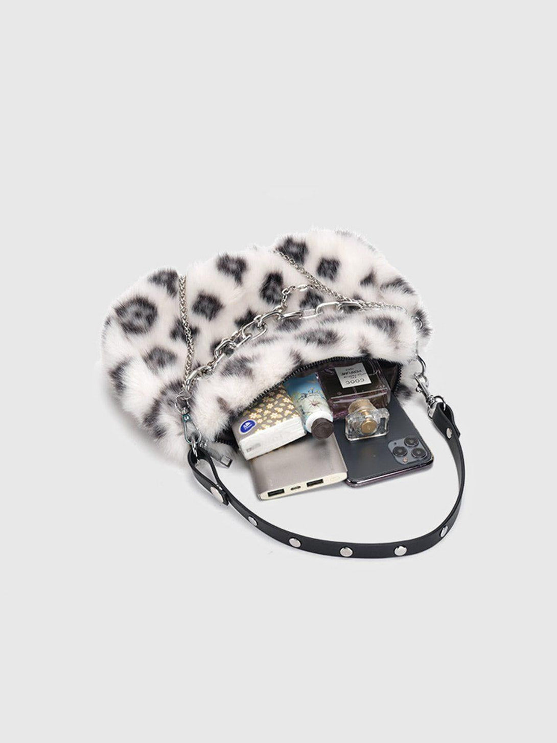 A stylish leopard fleece chain bag by TALISHKO, showcasing its spacious interior essentials.
