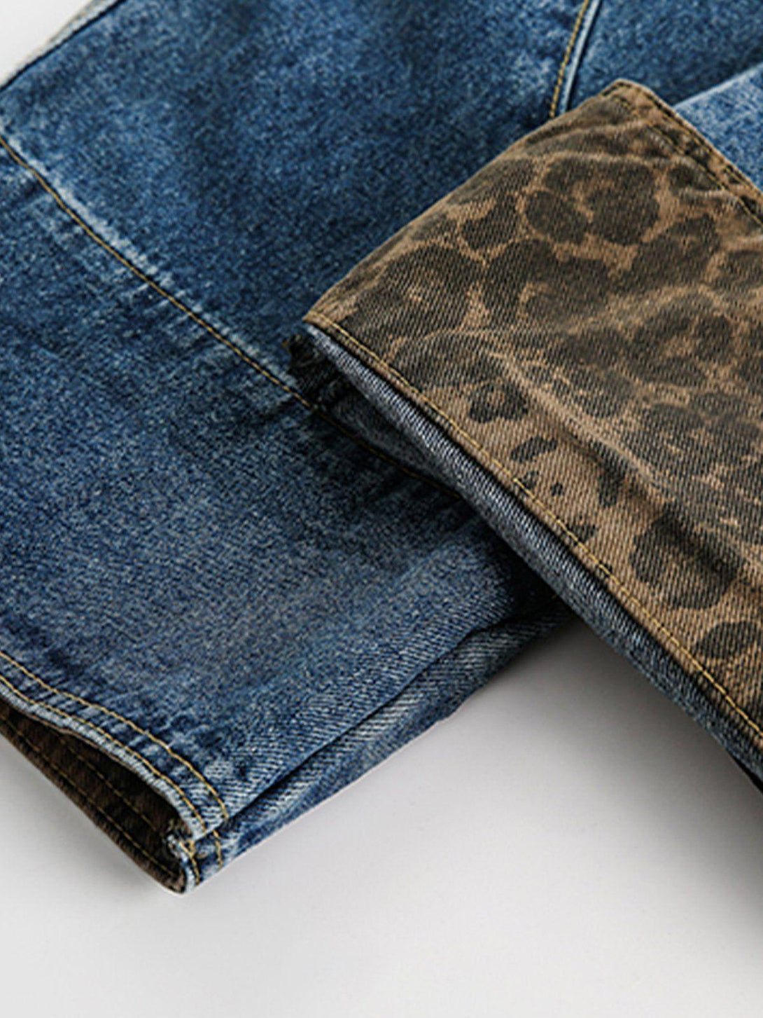 TALISHKO jeans detail showcasing leopard print cuffs and denim fabric for a unique style.