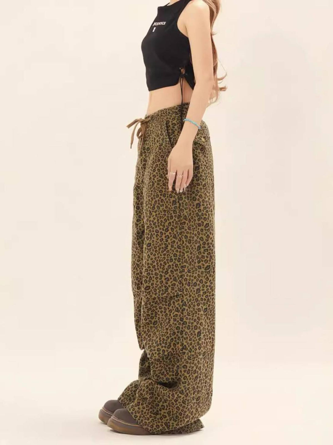 Side view of leopard print drawstring cargo pants by TALISHKO, styled with a black crop top.