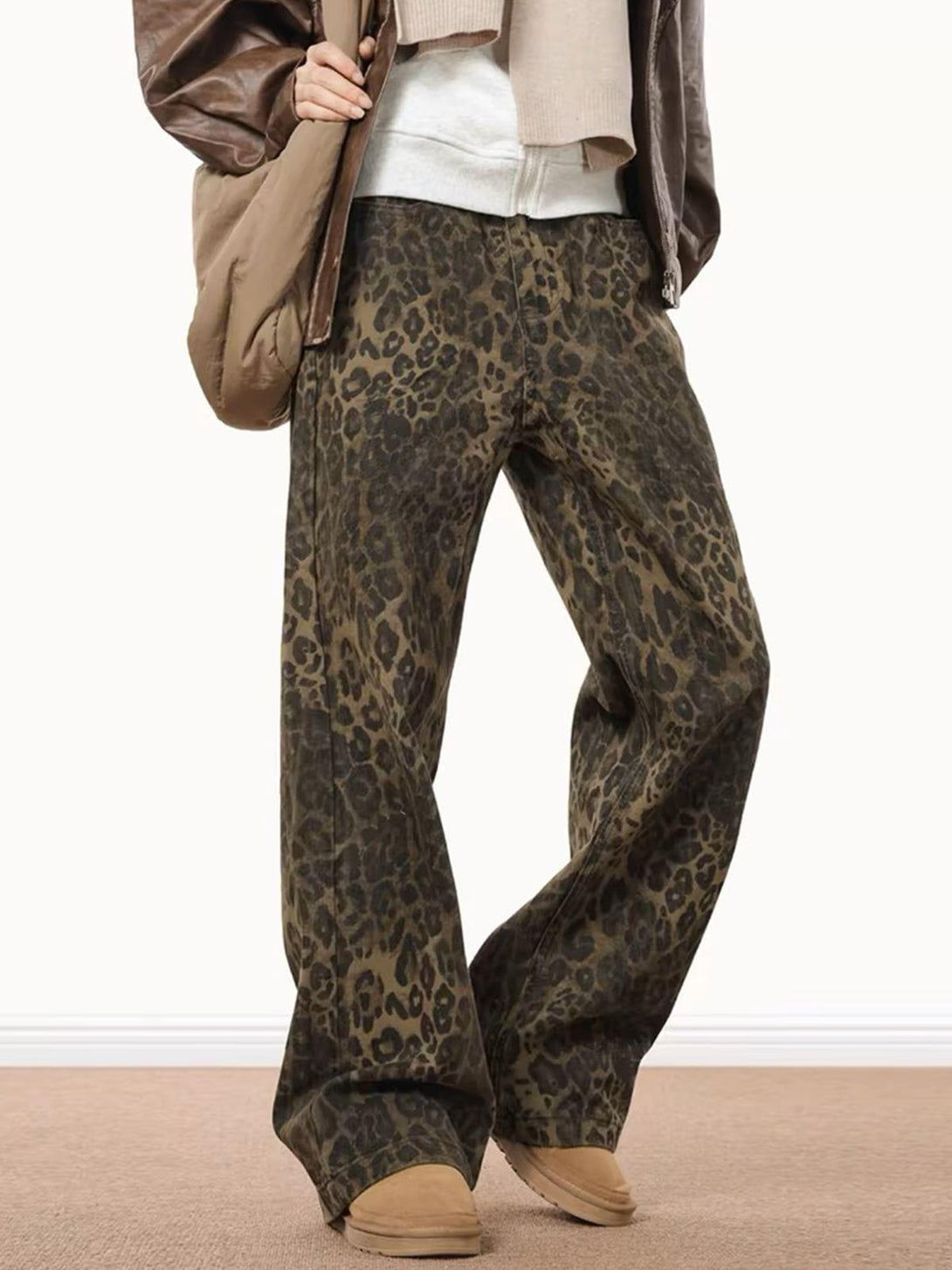 TALISHKO leopard print jeans in a relaxed fit, paired with cozy tan loafers for a chic look.