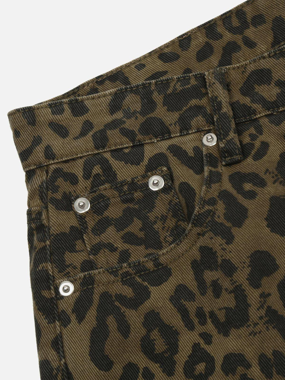 A detailed view of TALISHKO leopard print jorts, highlighting the bold pattern and texture.