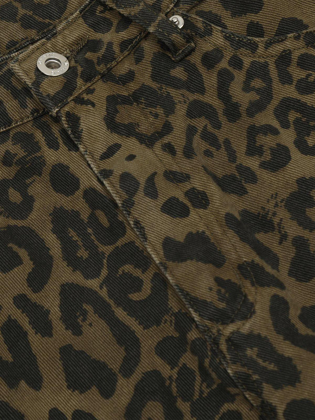 Intricate look at TALISHKO leopard print jorts, displaying bold pattern and texture details.