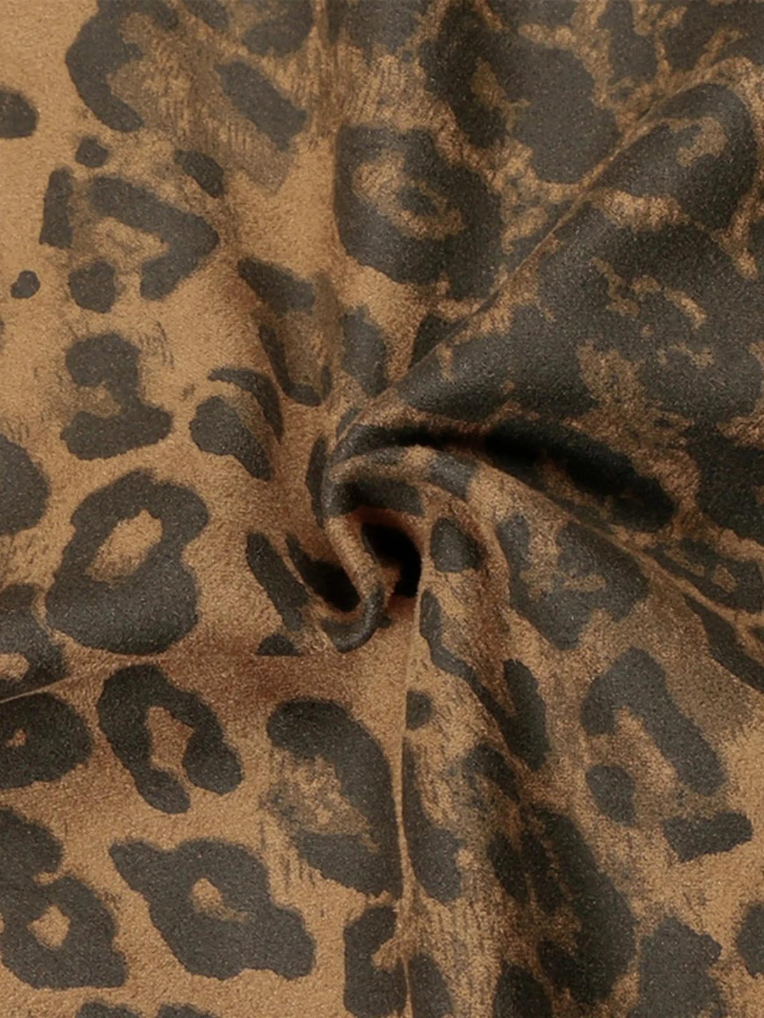 Zoomed-in texture of TALISHKO's leopard stripe sweatpants, highlighting the bold pattern.