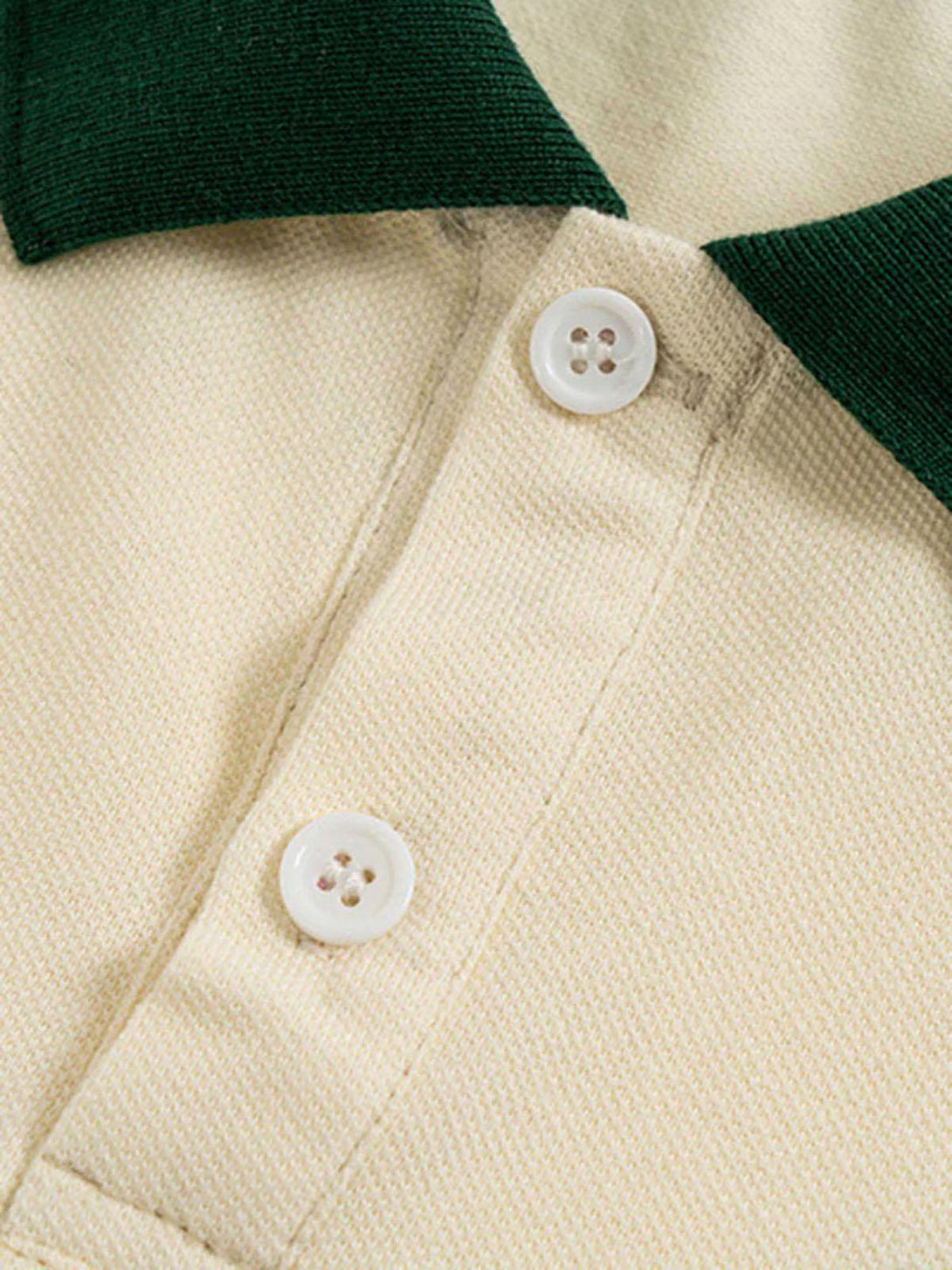 Focusing on the buttons and collar detail of a TALISHKO polo shirt with green accents.