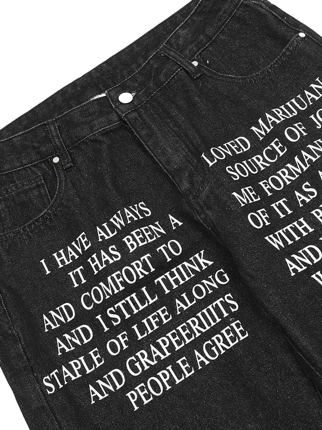 Detailed shot of TALISHKO hip-hop washed jeans, focusing on bold letter embroidery design.