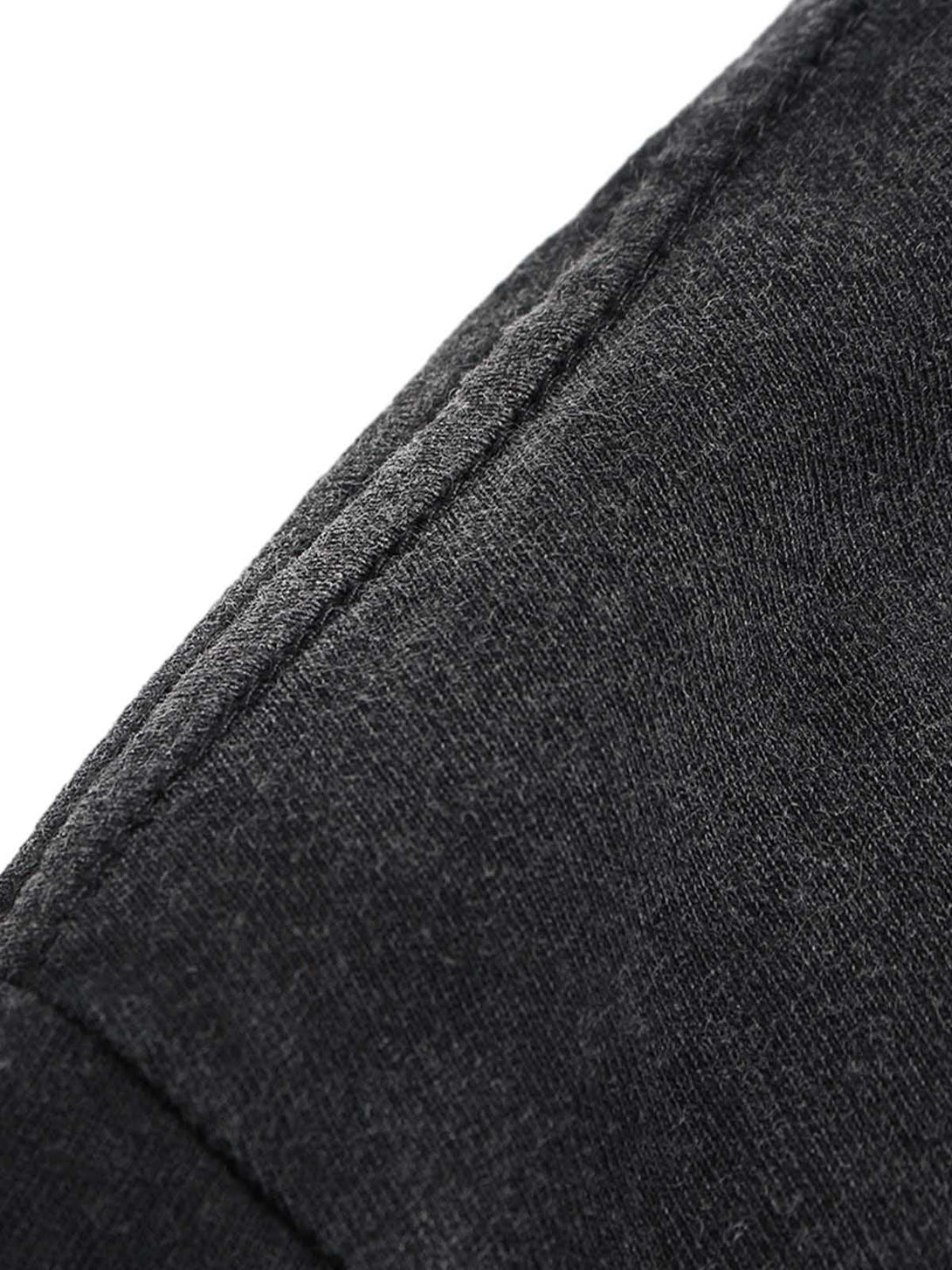 Detailed fabric and stitching of TALISHKO T-shirt, highlighting its dark, textured material.