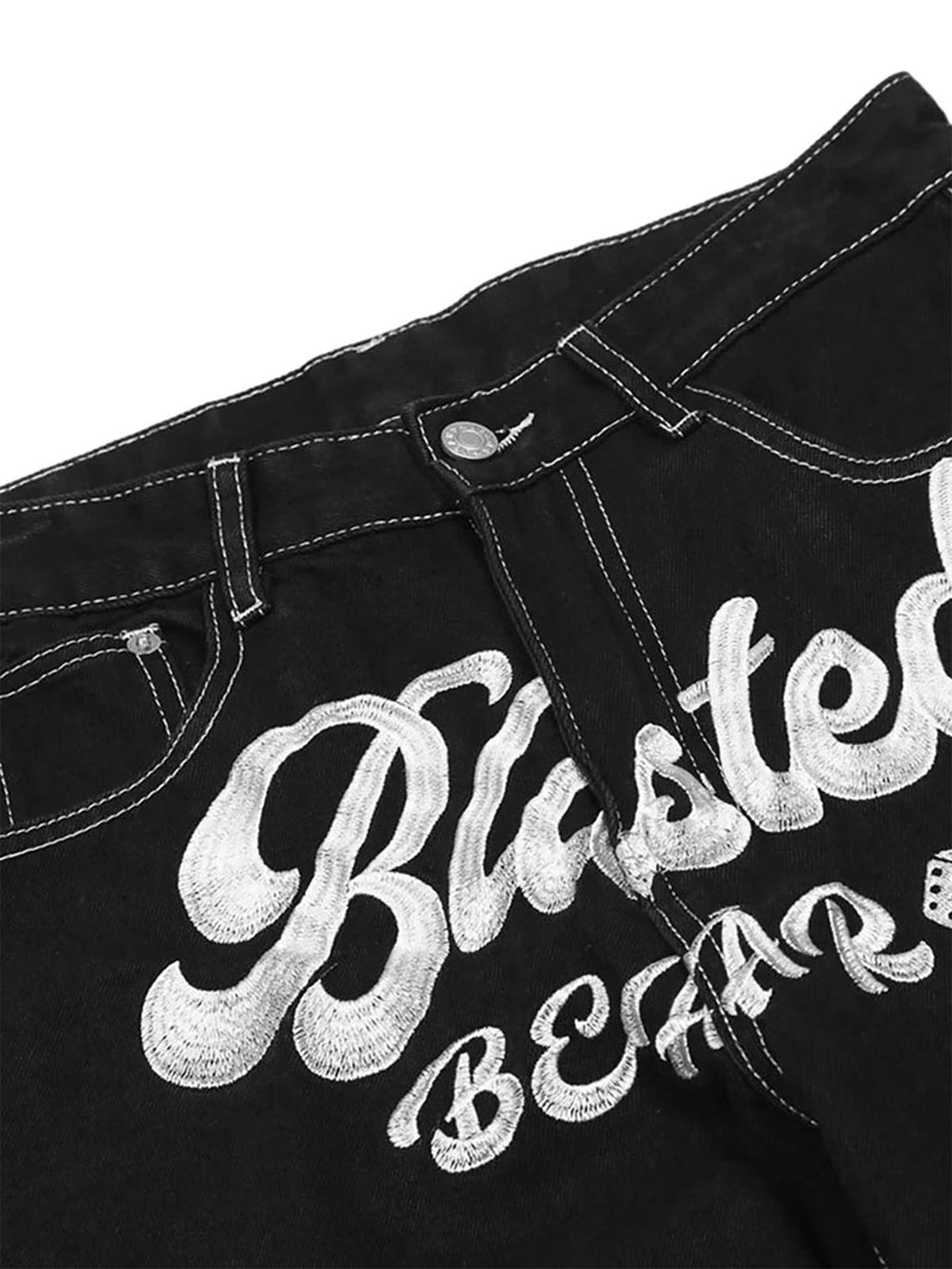 Intricate embroidery detail on TALISHKO's black baggy jeans, highlighting bold style.