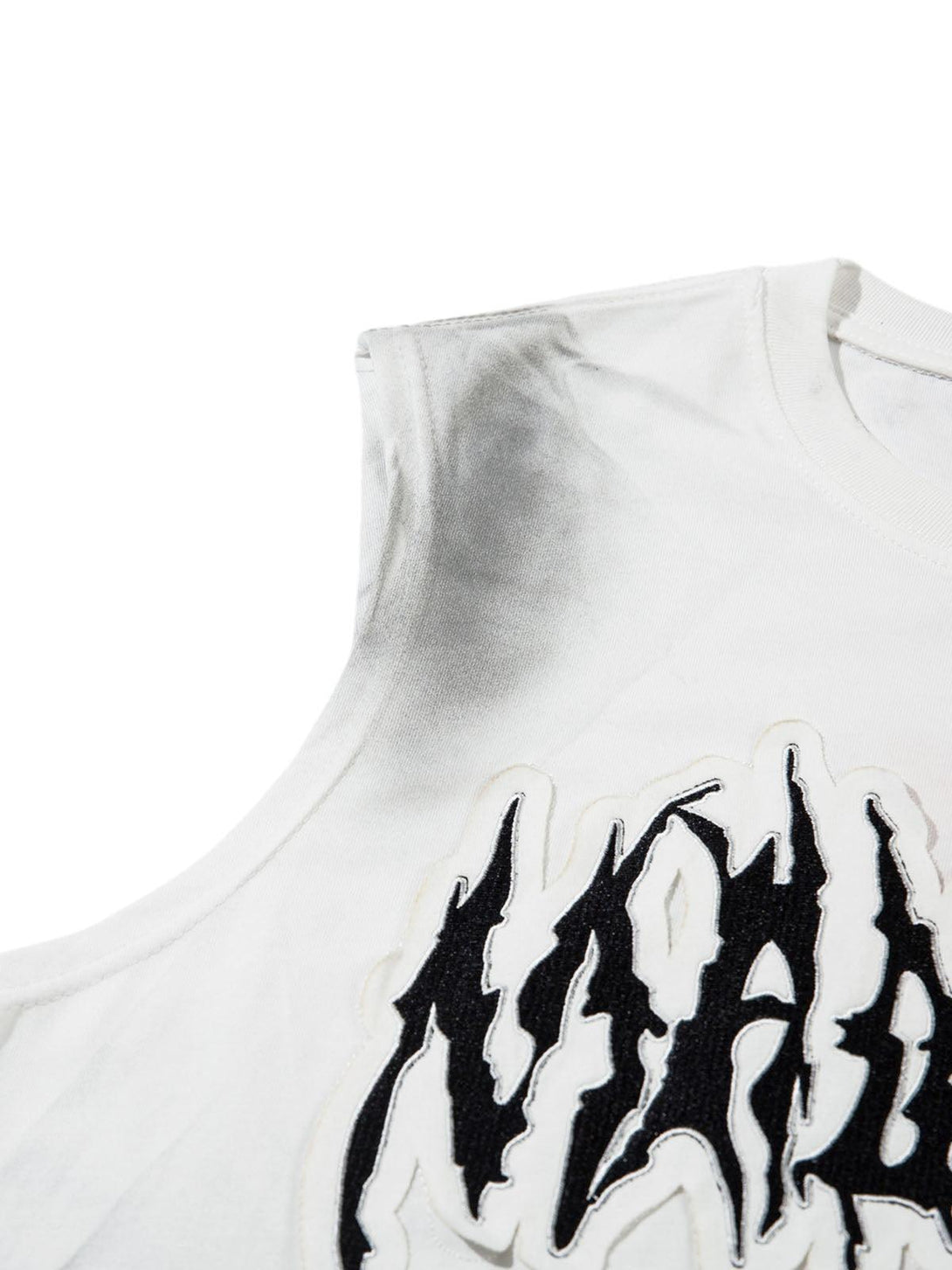 Zoomed-in view of a TALISHKO tank top, showcasing bold letter patchwork on a gradient fabric.