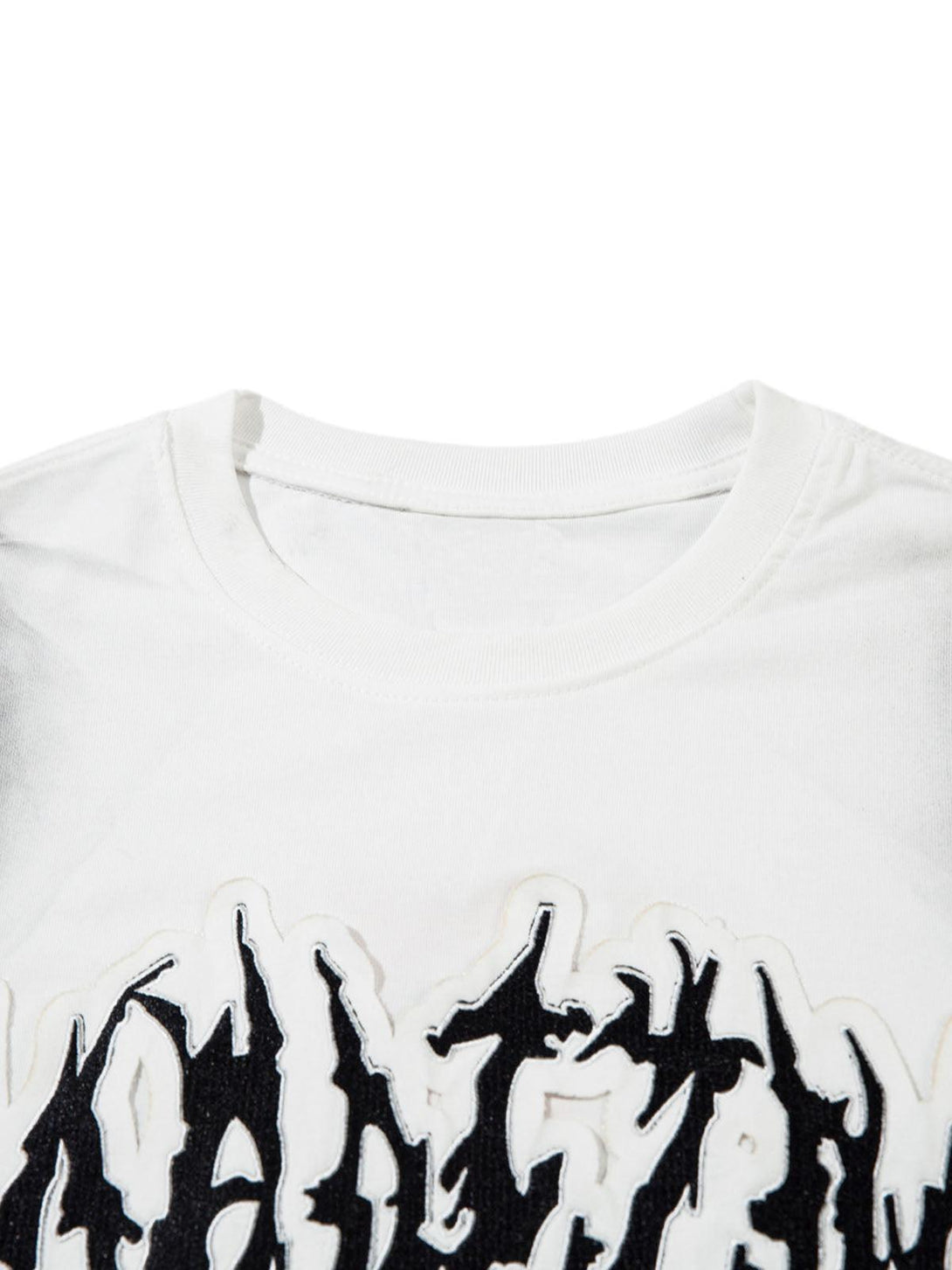 A close-up of a white tank top by TALISHKO, featuring bold black letter patchwork design.