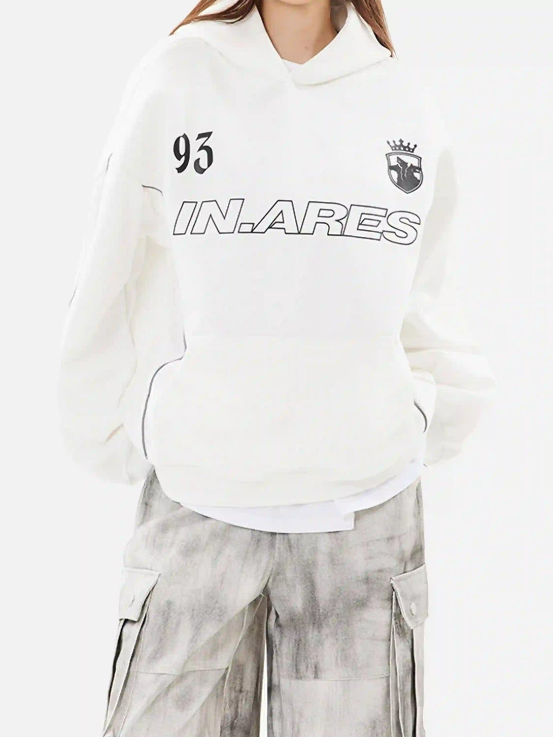 Model wearing a TALISHKO white hoodie with letter print and line design, paired with cargo pants.