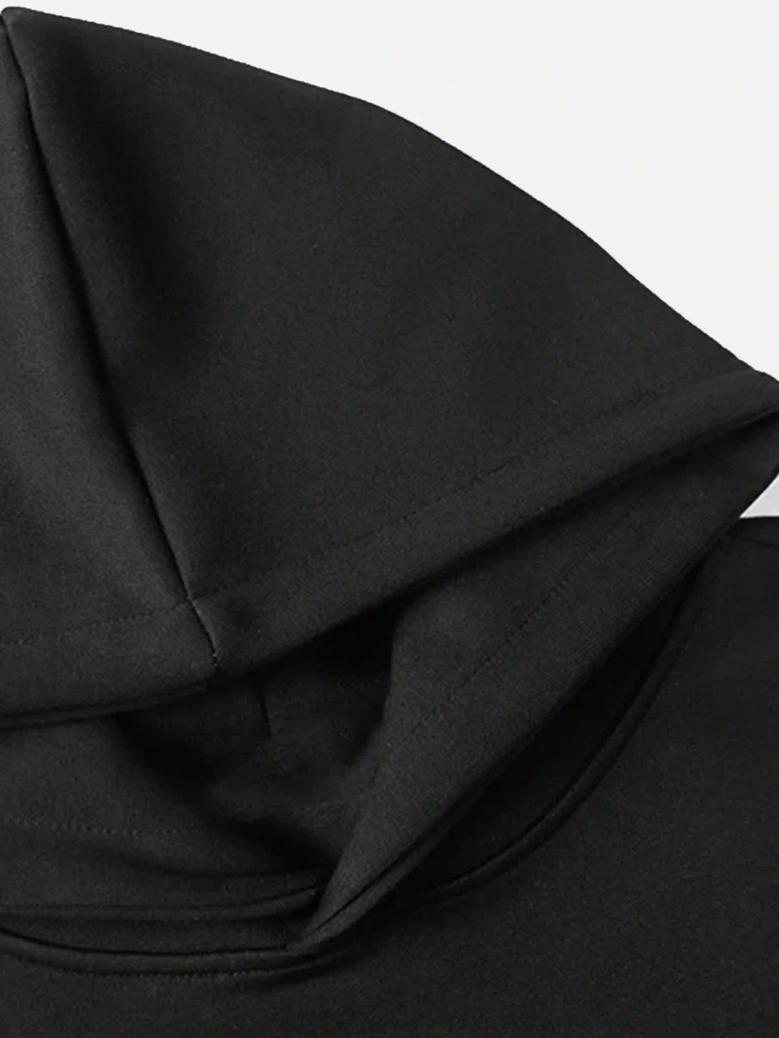 A detailed look at TALISHKO's black hoodie fabric, emphasizing the sleek hood design.