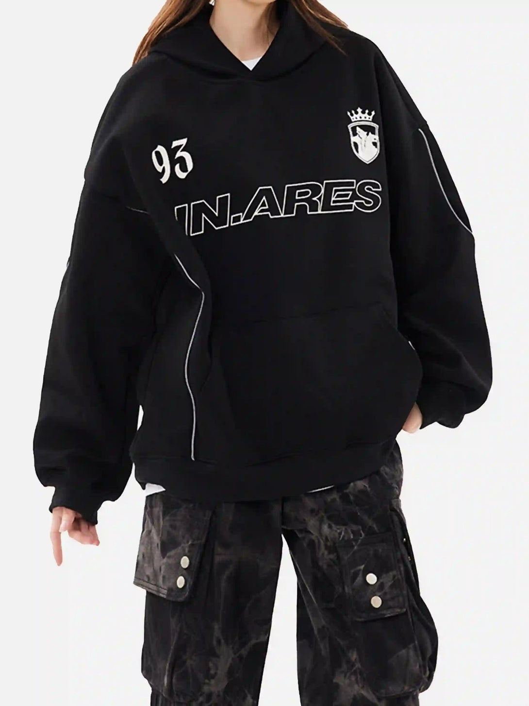 Model wearing a TALISHKO black hoodie with letter print and line details, paired with cargo pants.