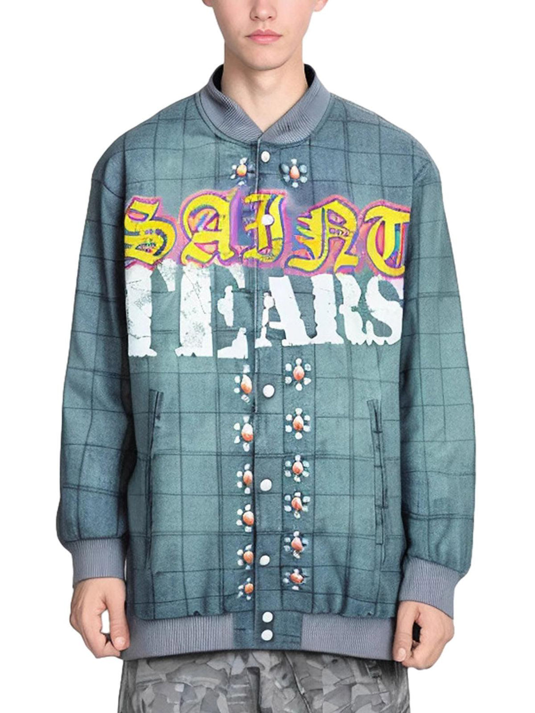 Model wearing TALISHKO's quilted bomber jacket with bold lettering and a checked pattern.