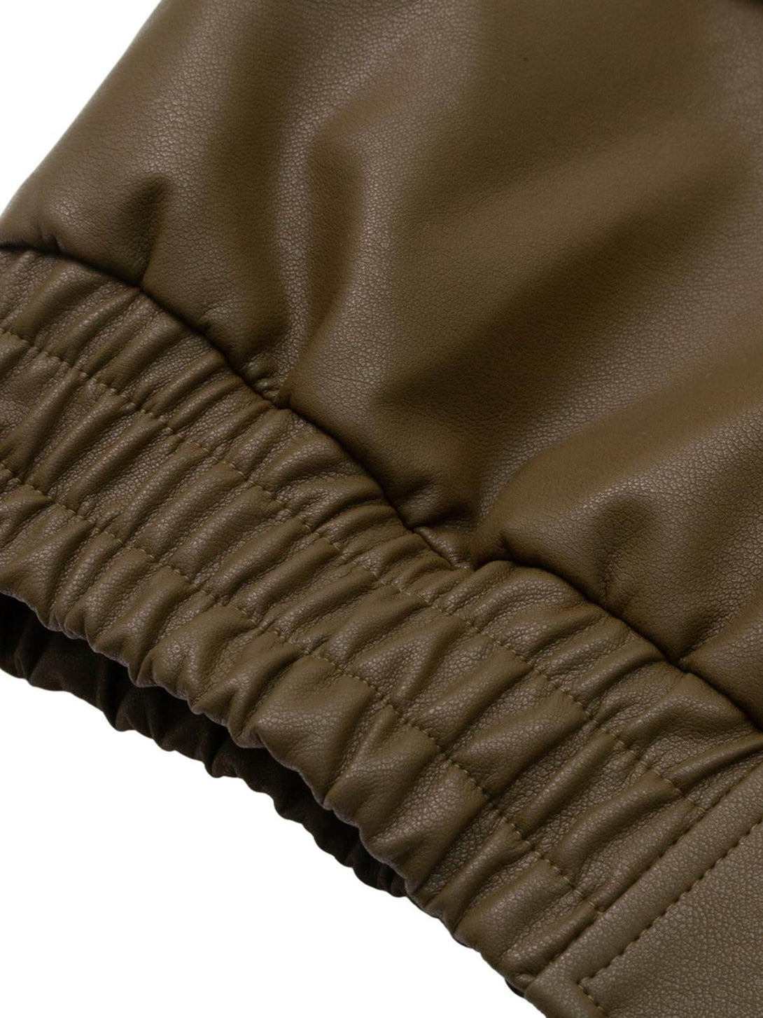 Focusing on the elastic cuff detail of a TALISHKO leather bomber jacket, highlighting its texture.