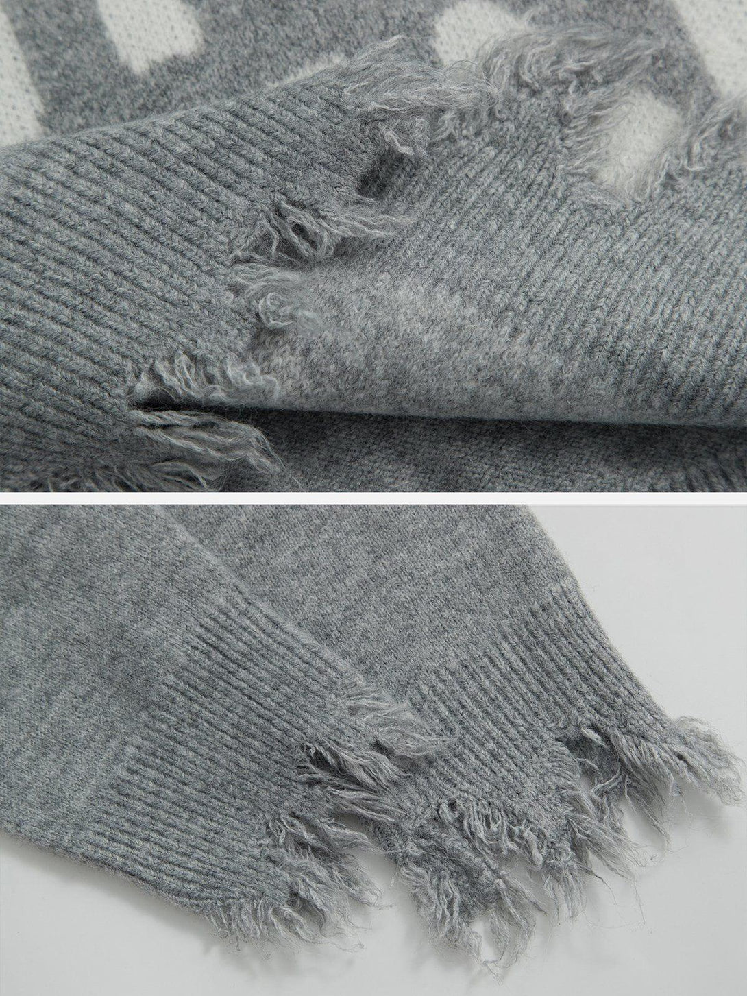 Detailed fabric and frayed edges of TALISHKO ripped hole sweater in a soft gray knit.