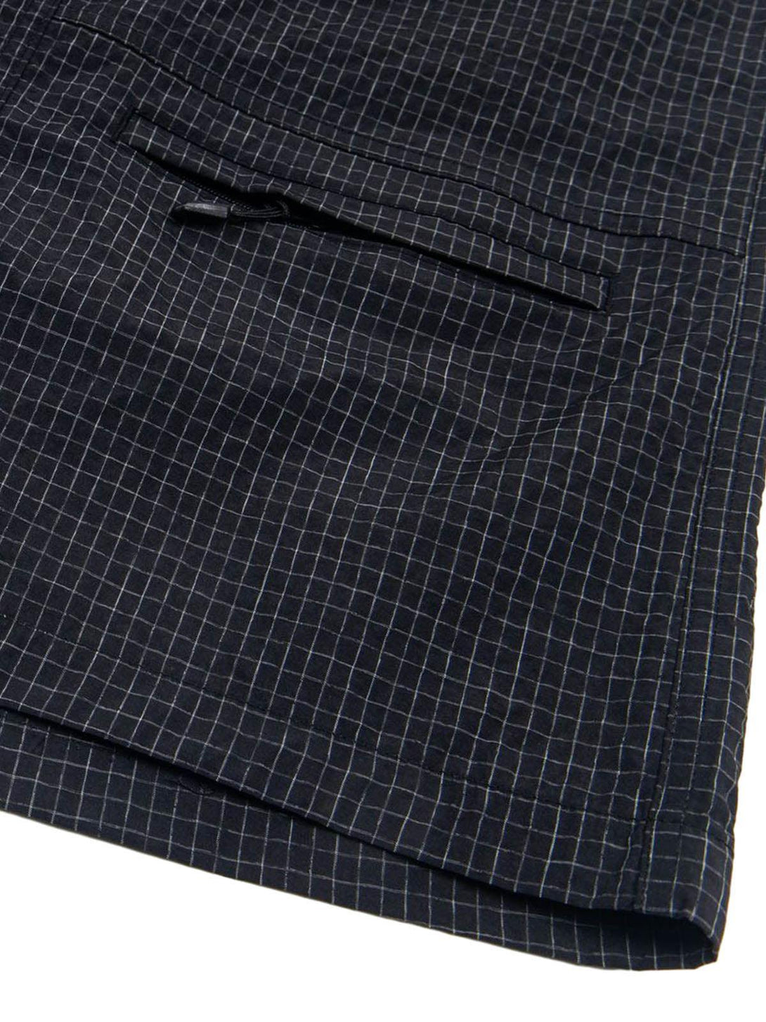 Detailed fabric and stitching on TALISHKO light quick-dry cargo shorts with checkered design.