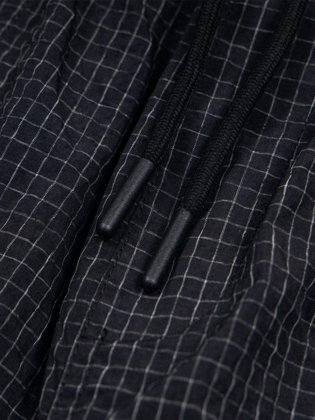 Intricate look at TALISHKO quick-dry cargo shorts with a detailed checkered pattern and drawstring.