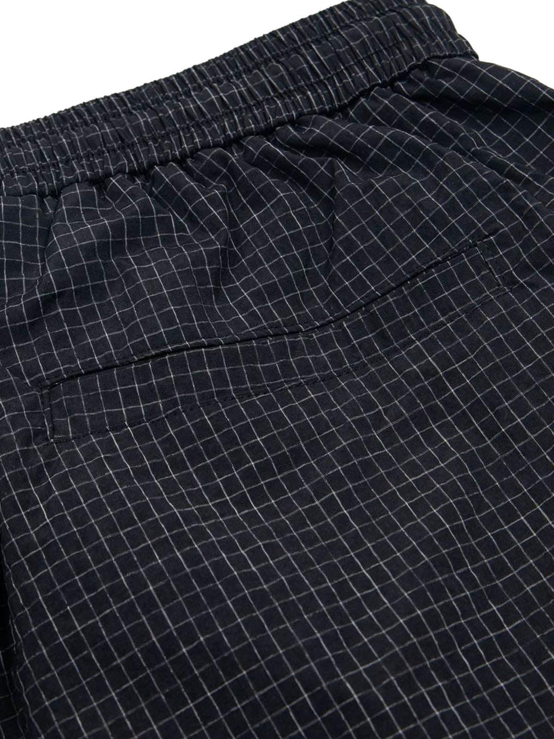 A close-up of TALISHKO quick-dry cargo shorts, highlighting the intricate checkered pattern.