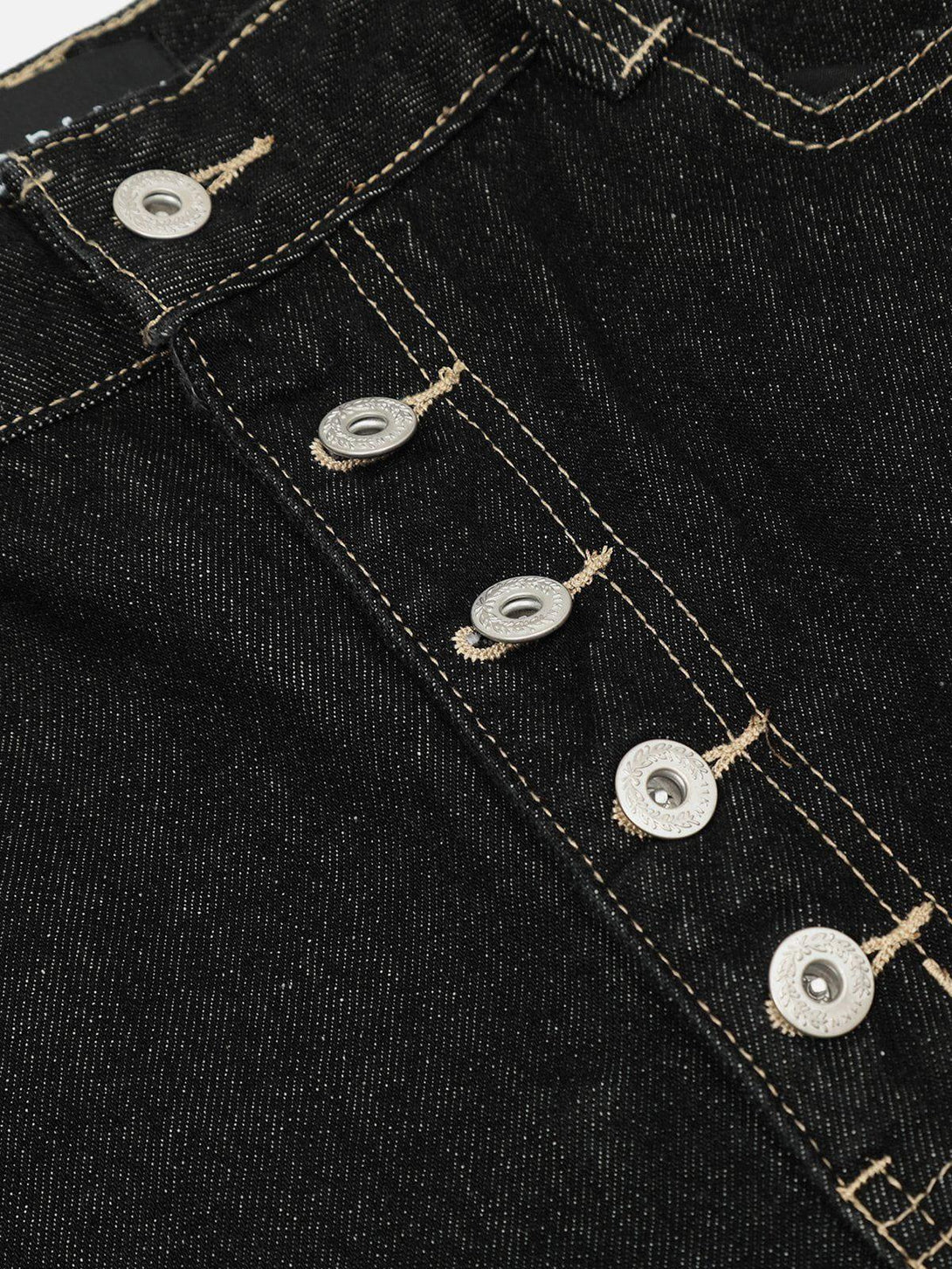 Focusing on the button detail of TALISHKO's barrel loose jeans, showcasing intricate stitching.