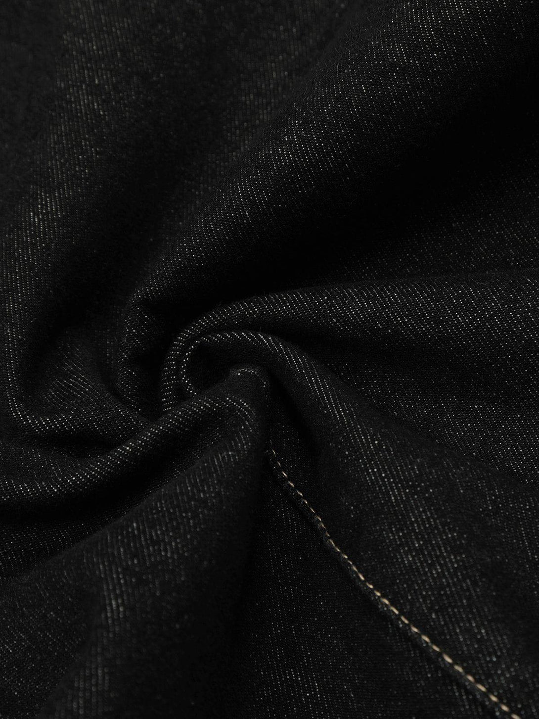 Detailed fabric and stitching of TALISHKO's black barrel loose jeans, highlighting texture and style.