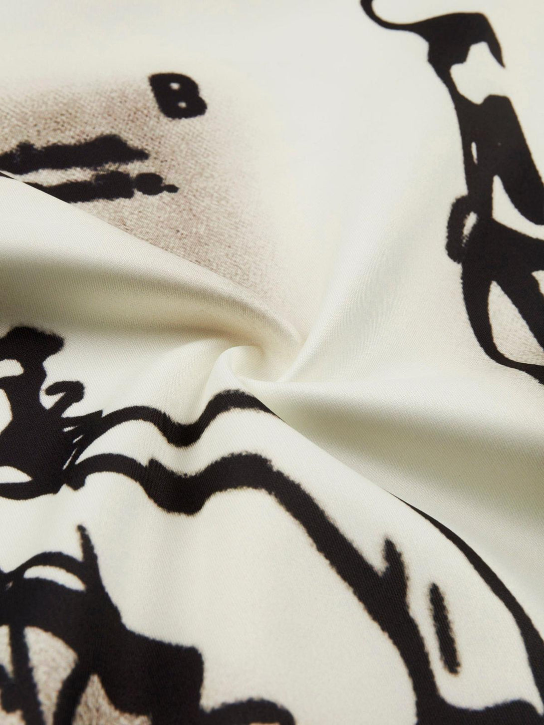 Intricate look at the abstract black design on TALISHKO's fabric, showcasing unique character art.