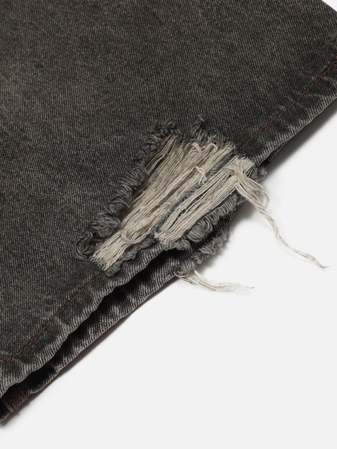 Frayed hem detail on TALISHKO loose jeans with a washed finish and unique line print.