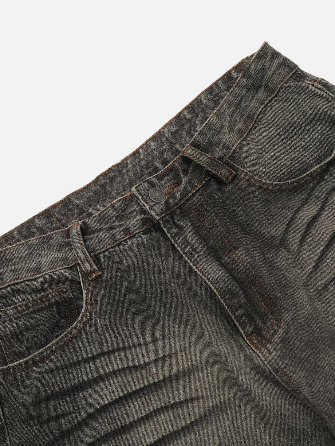 A detailed look at TALISHKO's washed loose jeans, showcasing unique line prints and texture.