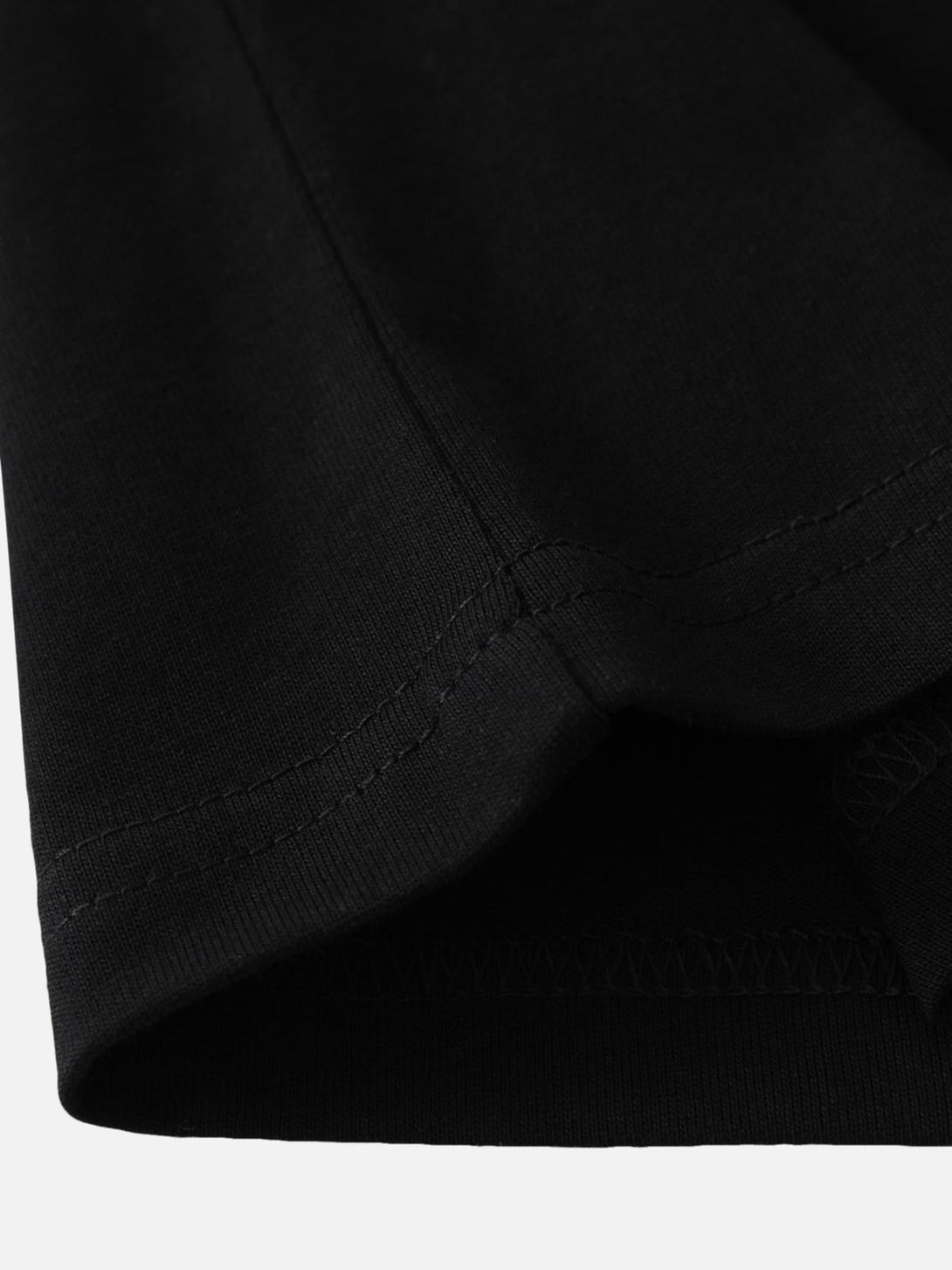 Detailed fabric and stitching of a black t-shirt by TALISHKO, highlighting its quality craftsmanship.