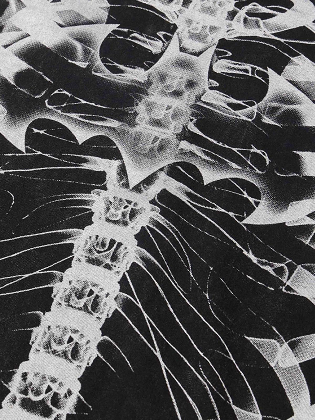 Intricate look at the ribcage print on a washed T-shirt by TALISHKO, emphasizing retro style.