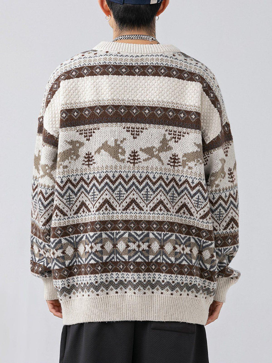 Back view of a TALISHKO loose vintage sweater with detailed geometric and animal patterns.