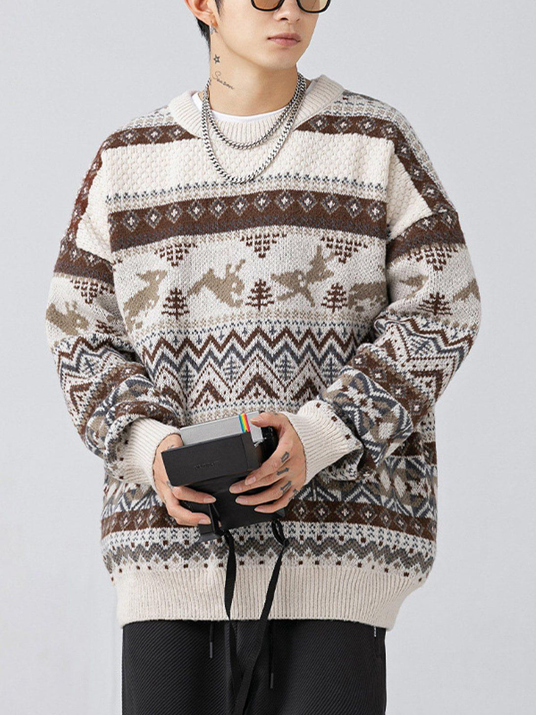 A model wears a TALISHKO loose vintage sweater with a detailed brown and beige pattern.