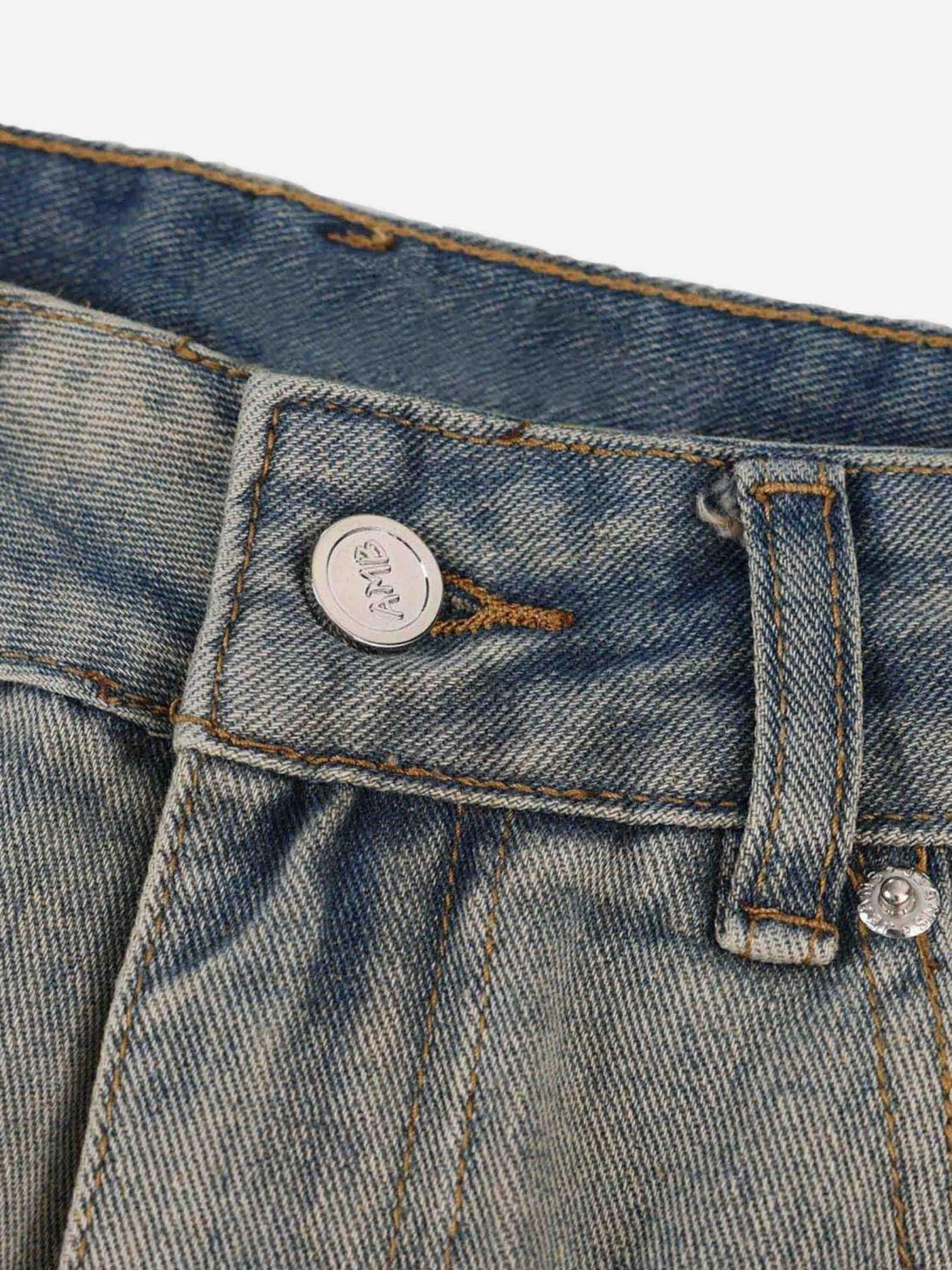 Focusing on the TALISHKO jeans button and stitching details, highlighting quality craftsmanship.