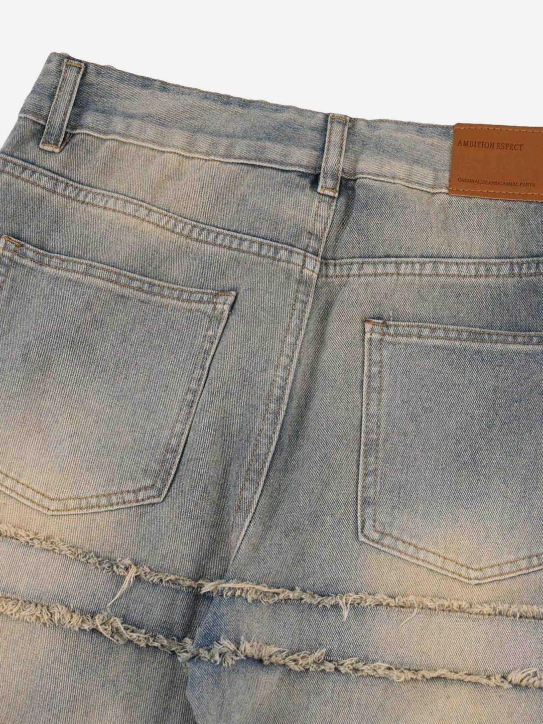 Back view of TALISHKO jeans with frayed details, showcasing a unique texture and style.