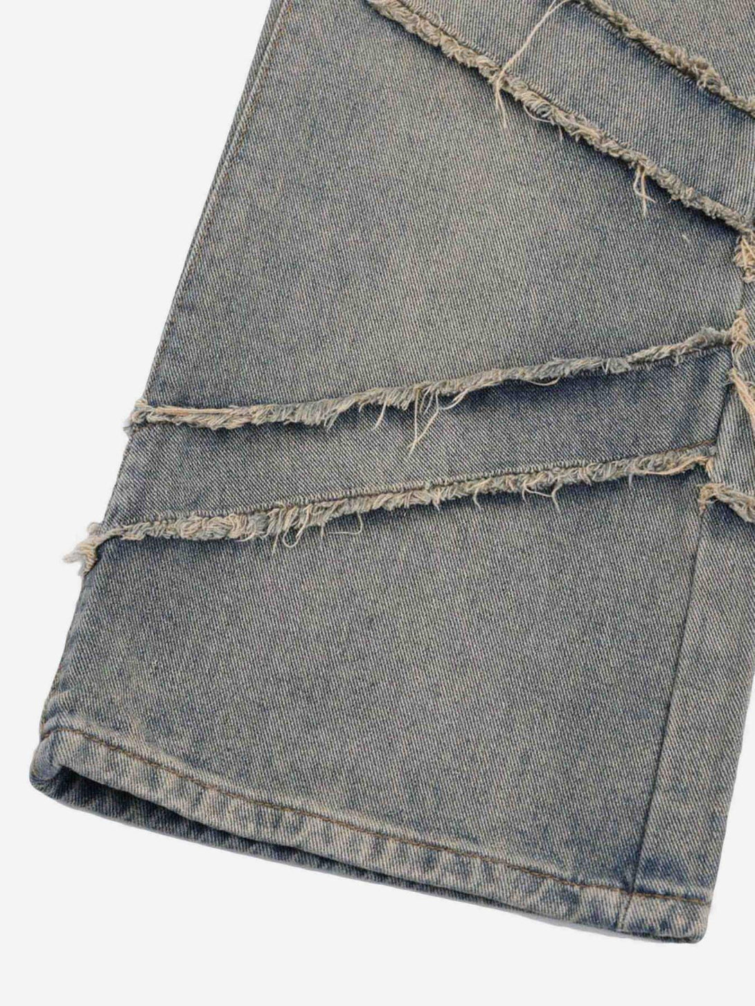 Detailed fabric and frayed diagonal patterns on TALISHKO jeans, highlighting unique texture.
