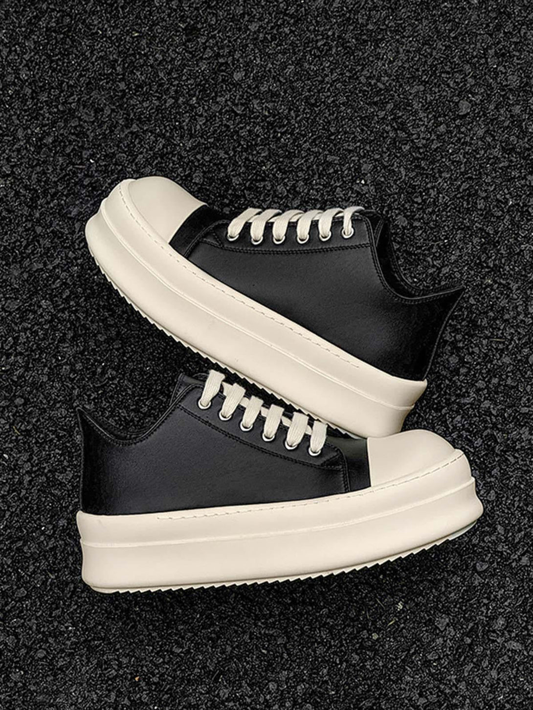 Low-top sneakers by TALISHKO in black and cream with chunky soles, ideal for a casual look.