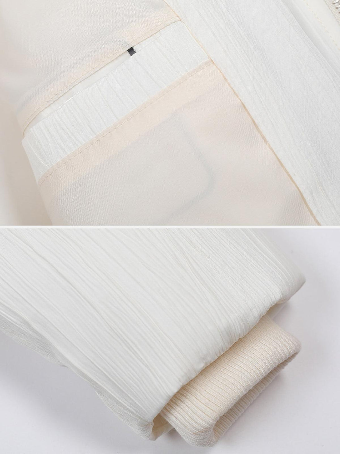 Intricate look at TALISHKO puffer coat's textured fabric and ribbed cuff detail.
