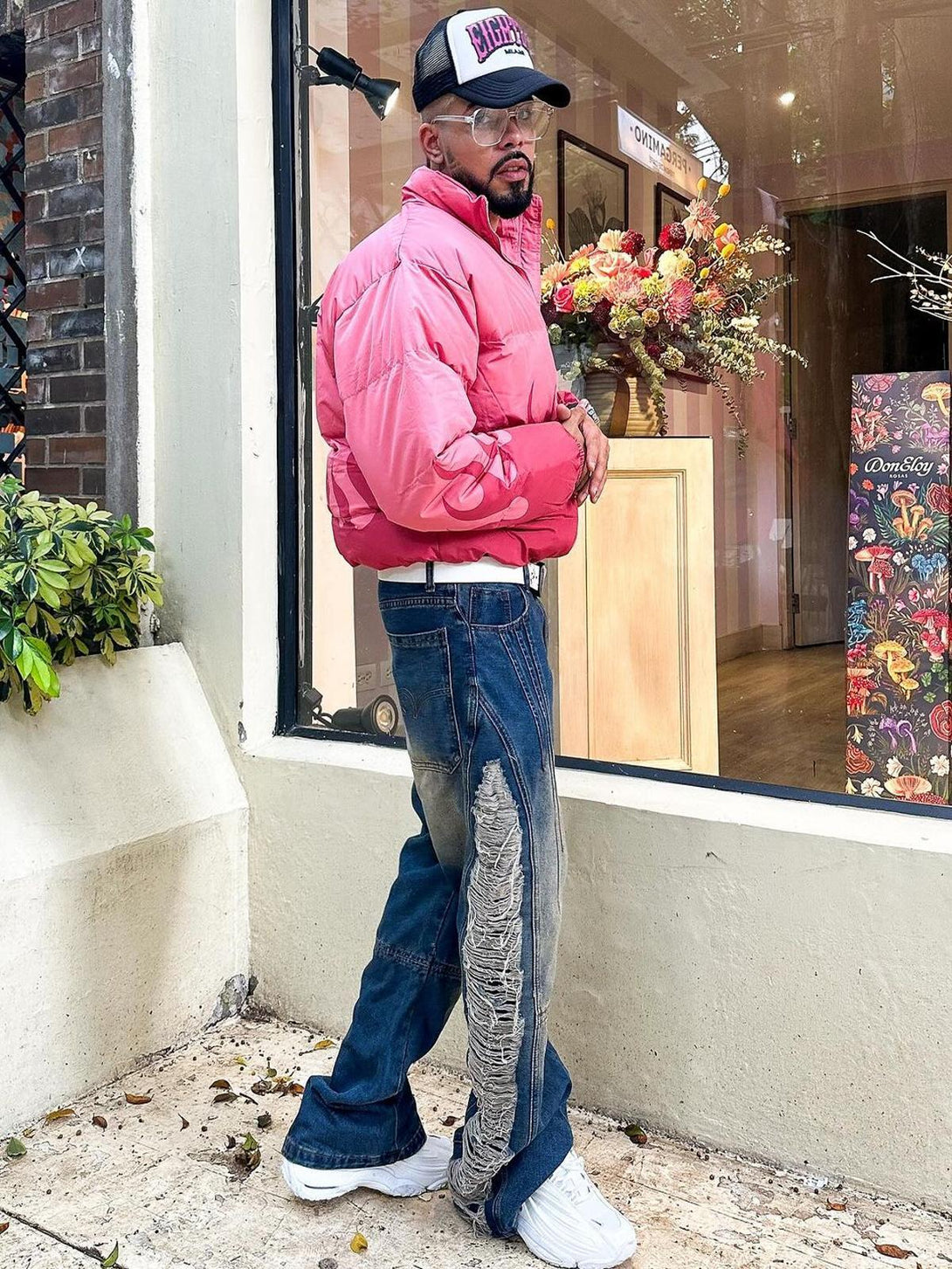 Model wearing TALISHKO Maillard Hottie Ripped Jeans with a pink puffer jacket, adding urban edge.