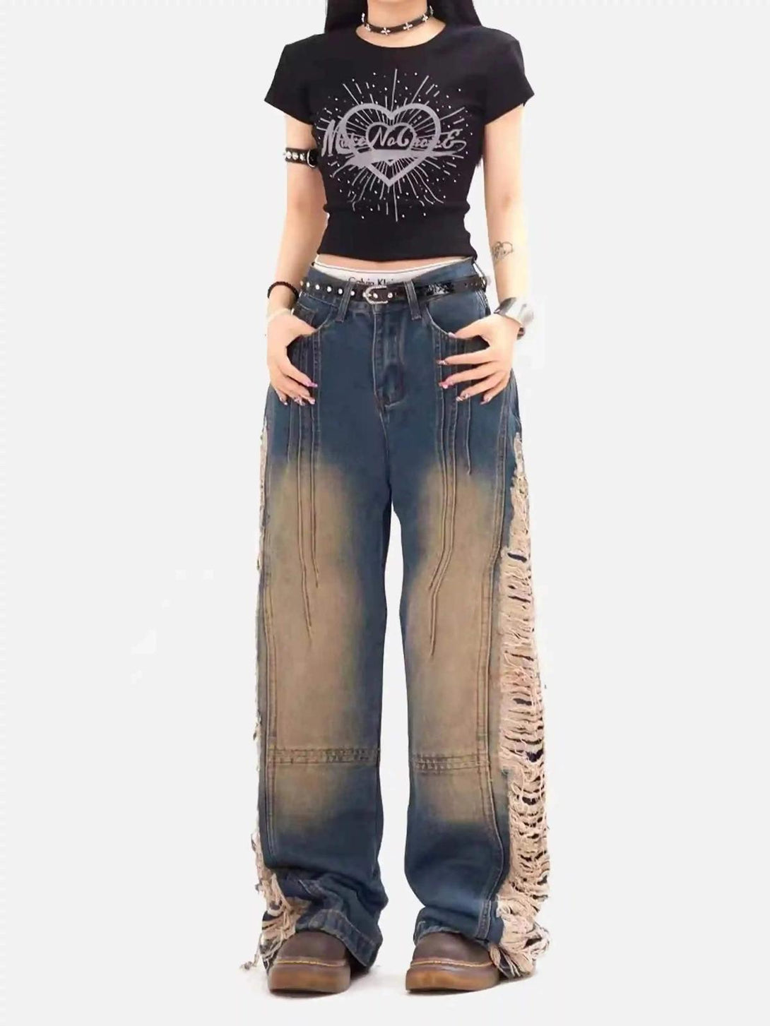 Model wearing TALISHKO Maillard Hottie Ripped Jeans with a graphic tee, embracing edgy style.