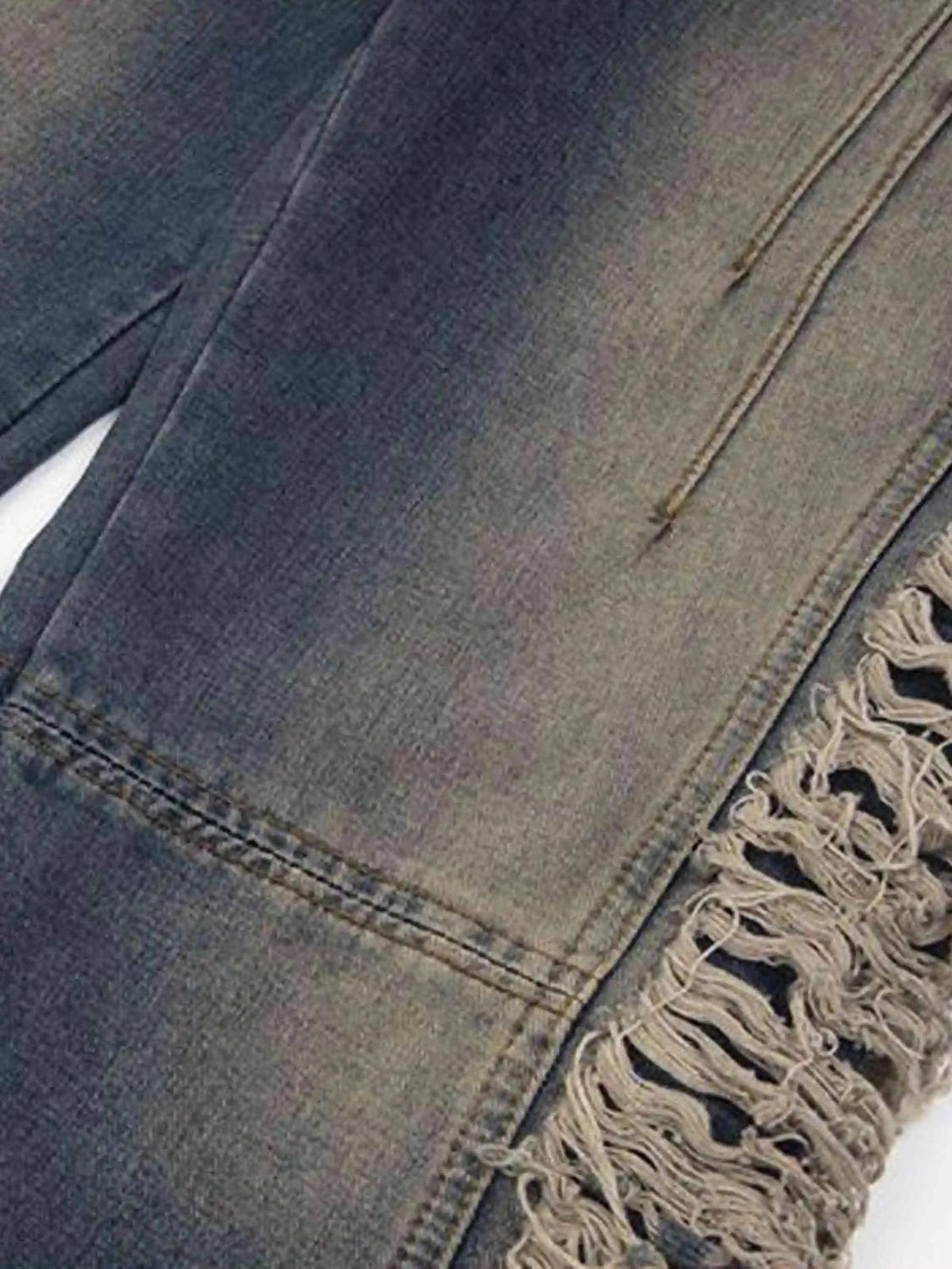 A detailed look at TALISHKO Maillard Hottie Ripped Jeans, highlighting unique side fraying.