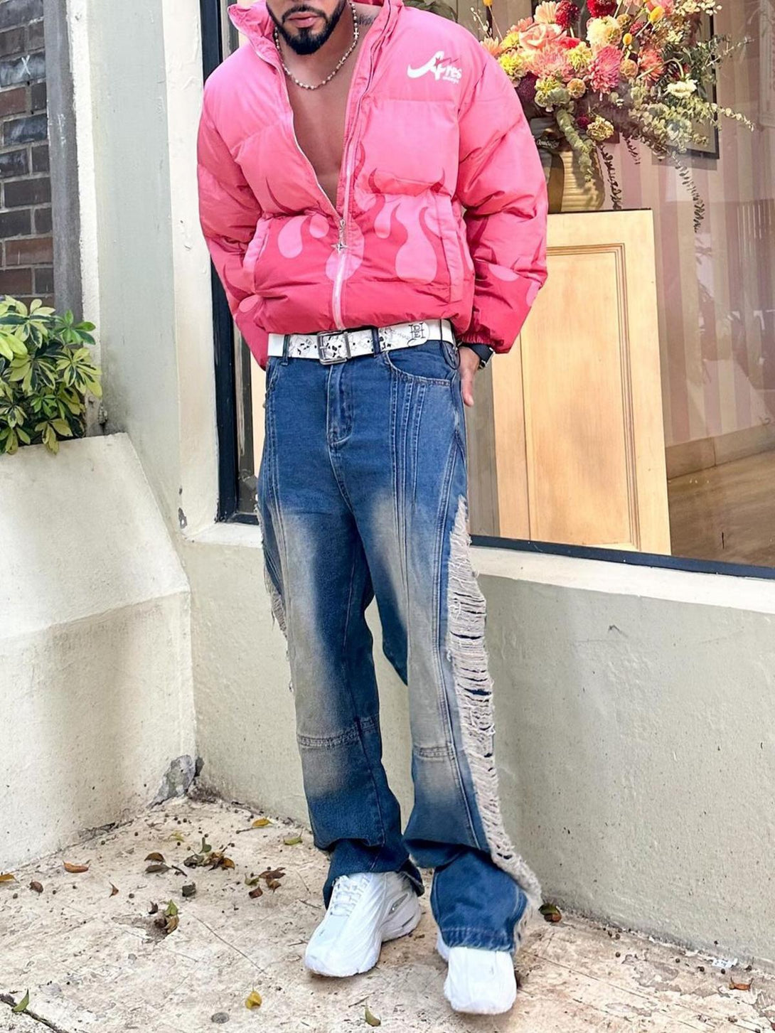 TALISHKO ripped jeans paired with a vibrant pink jacket, showcasing bold street style flair.