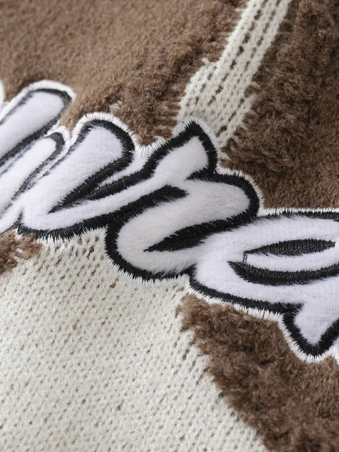 Detailed fabric and stitching of TALISHKO's Maillard Star Tassel Ripped Sweater, showcasing texture.