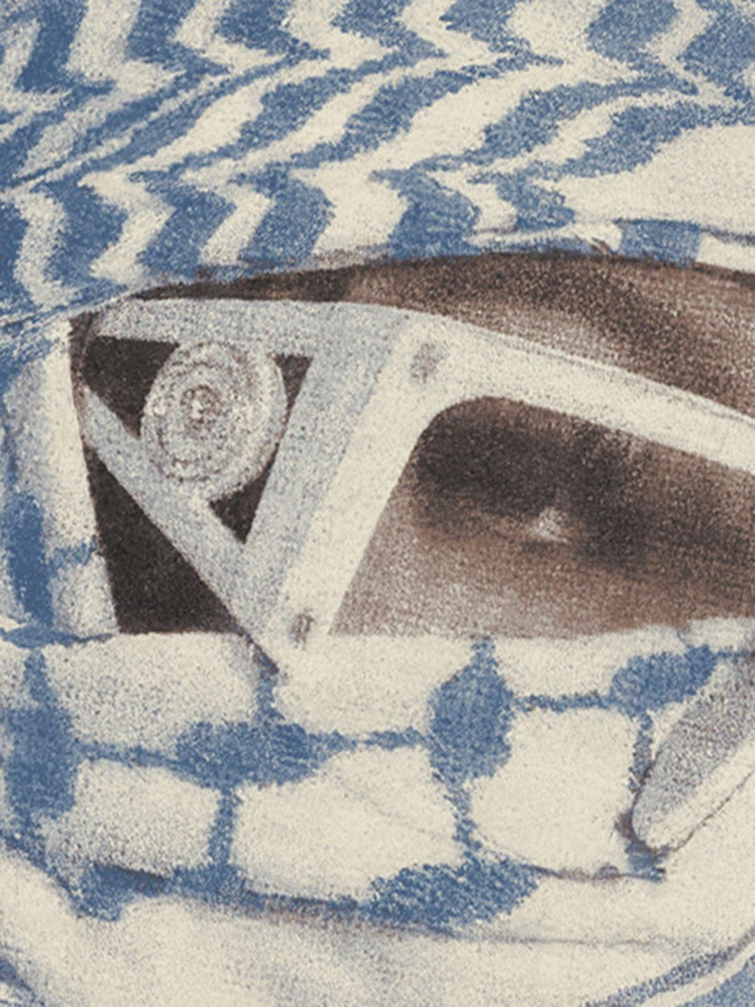 Intricate look at TALISHKO's graphic T-shirt, focusing on the masked portrait design.