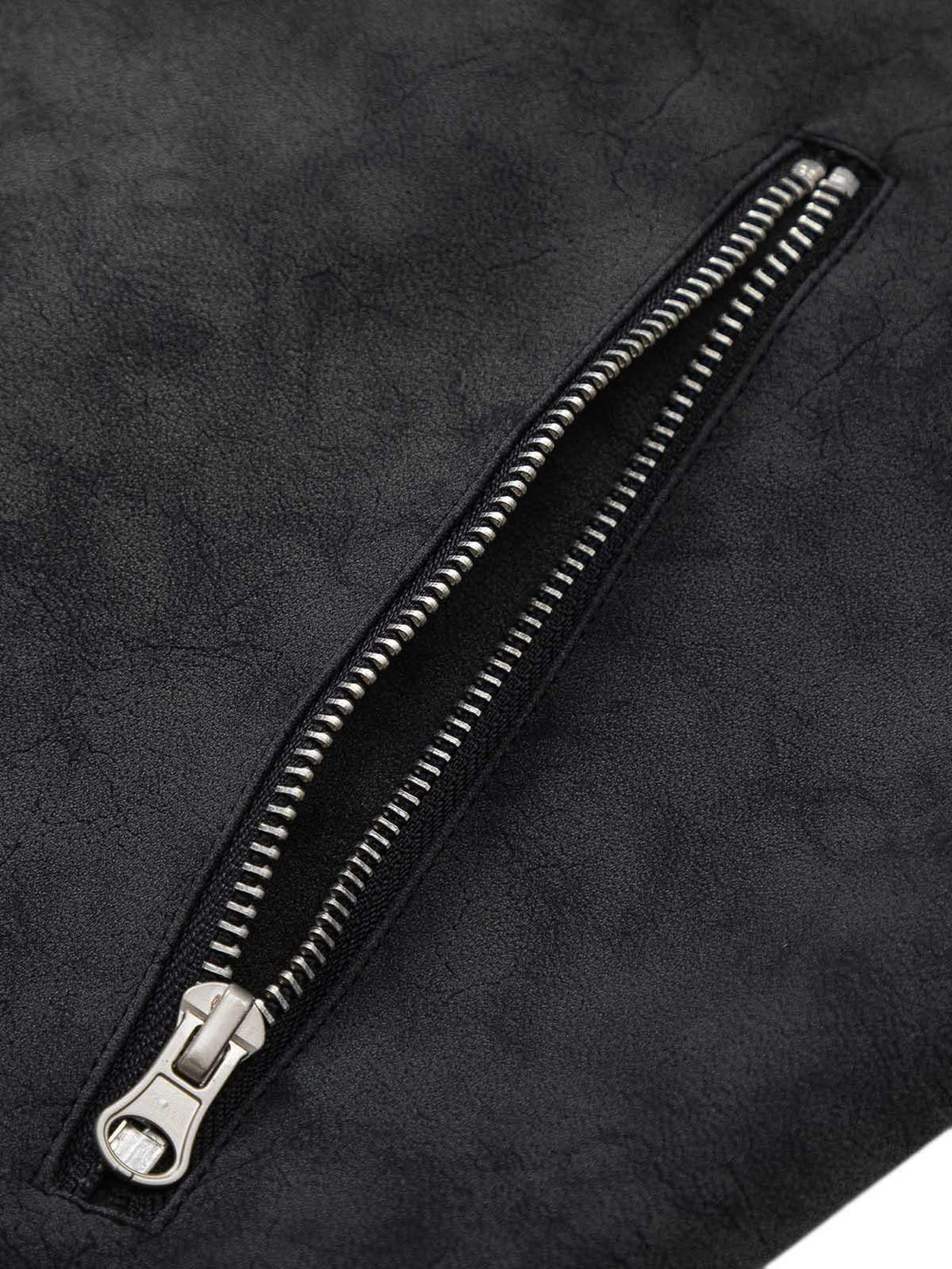 A tight crop highlighting the zipper detail on a matte PU moto leather jacket by TALISHKO.