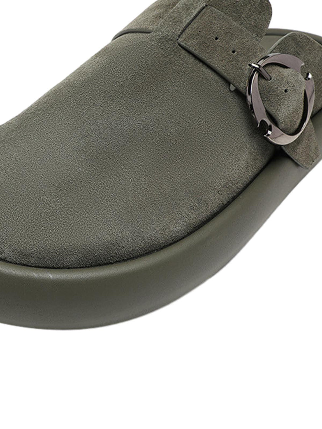 A close-up of TALISHKO's suede closed-toe slip-on shoes, showcasing the elegant buckle detail.