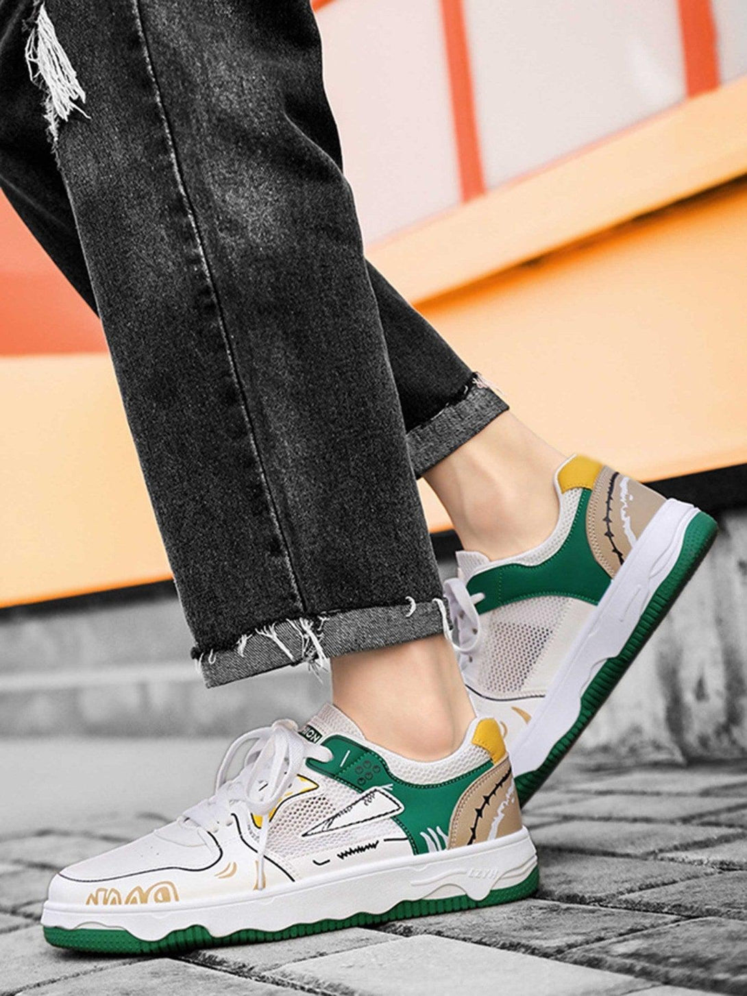 TALISHKO mesh board shoes with green and yellow accents, styled with casual black denim.