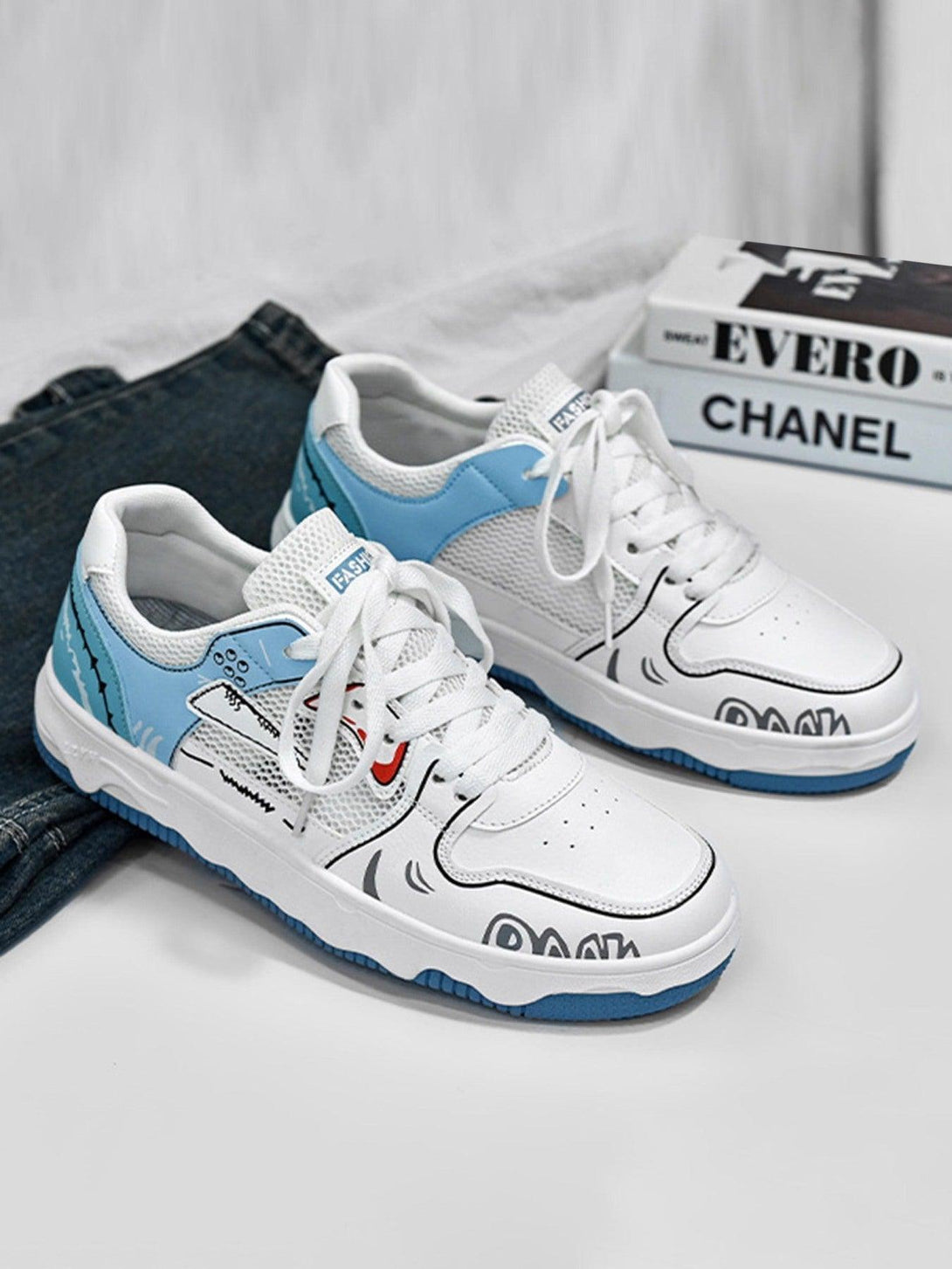 Mesh board shoes by TALISHKO featuring playful graphics and blue accents, styled against denim.