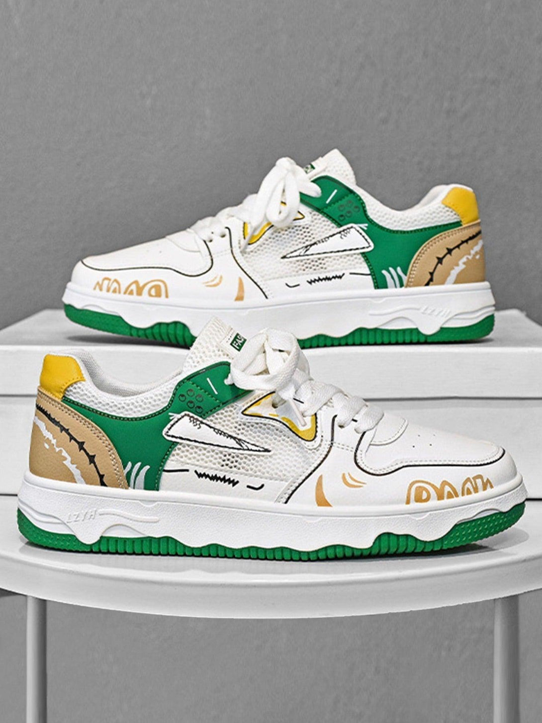 TALISHKO mesh board shoes in white, green, and yellow with bold graphic details, shown side view.