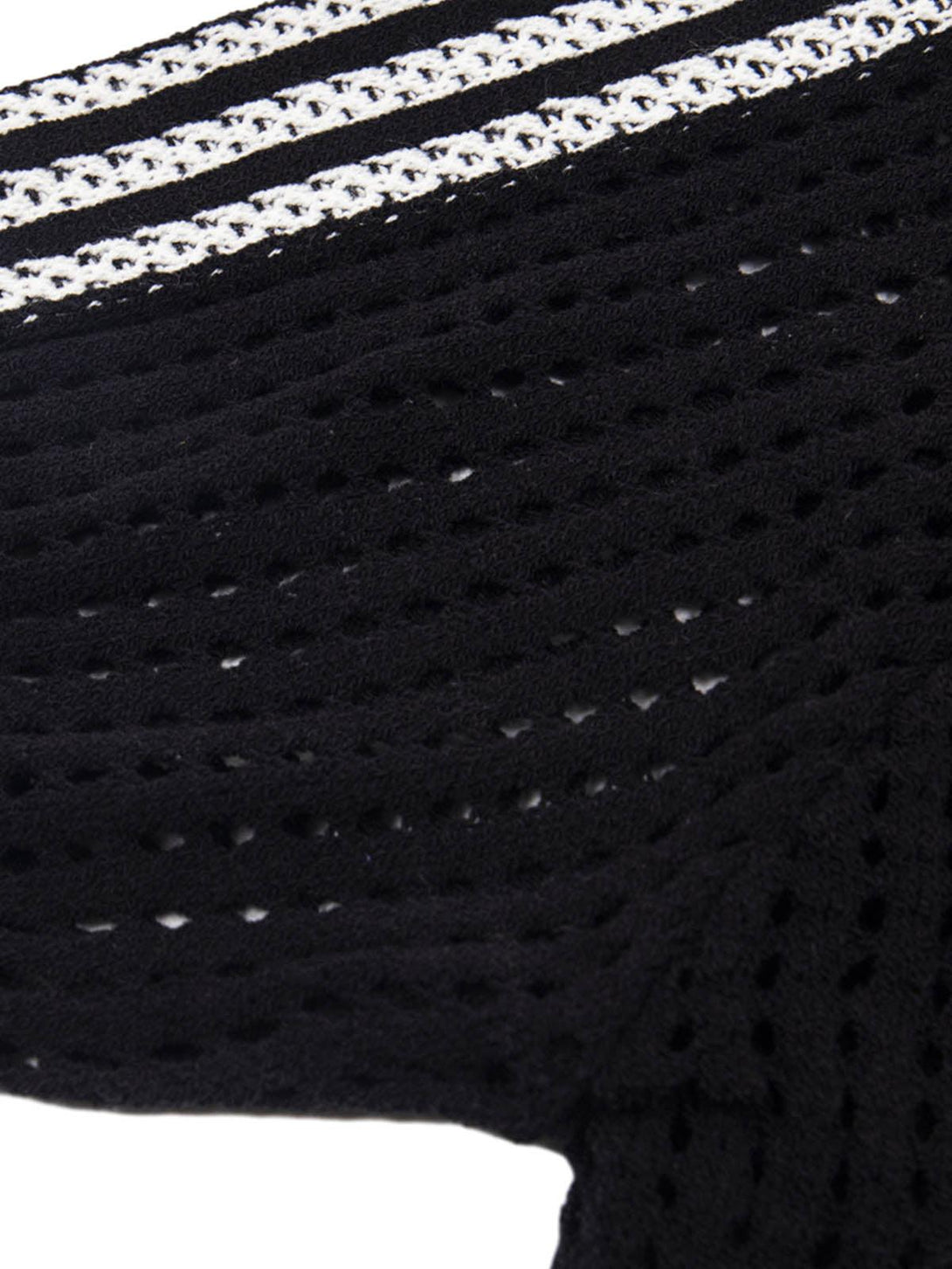 A detailed view of the black mesh knit texture with white accents by TALISHKO.