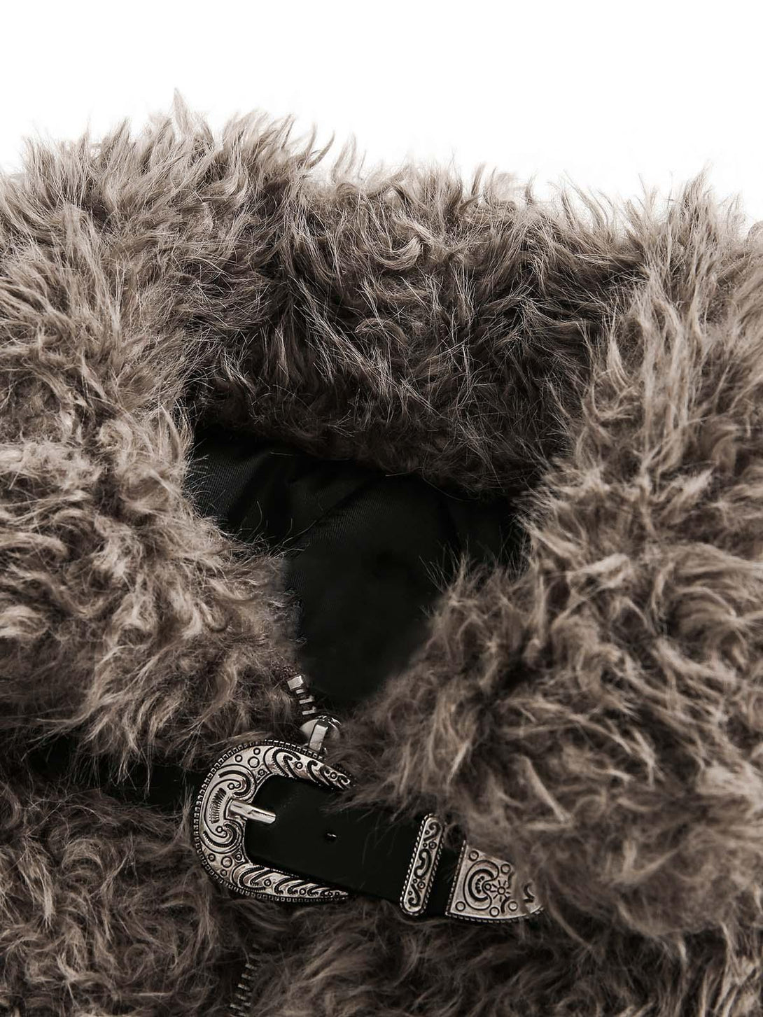 A detailed view of the textured faux fur and intricate metal leather buckle by TALISHKO.