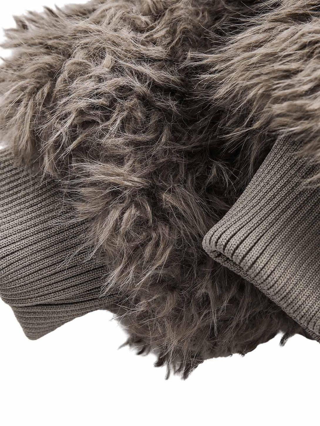A tight crop highlighting the plush faux fur texture and ribbed knit details by TALISHKO.